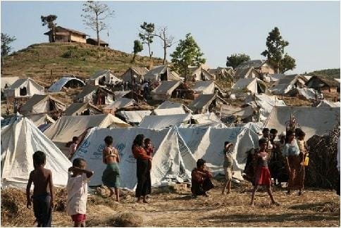 temporary settlement of refugee families across a barren landscape, symbolizing global humanitarian responsibility